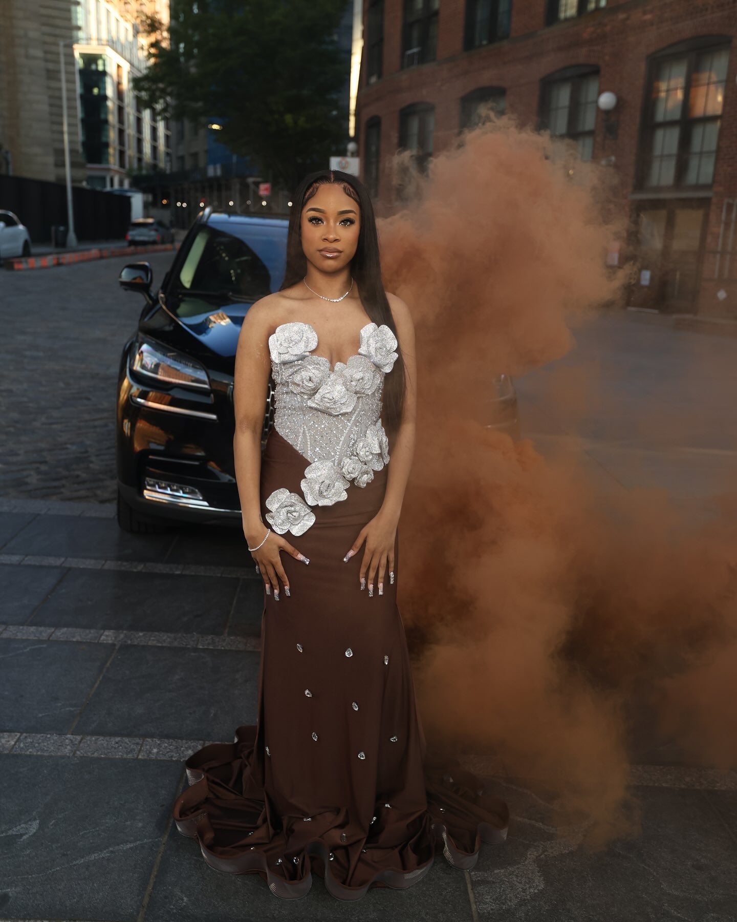 Chocolate Brown Mermaid Prom Dress Strapless Sweetheart Sheer Illusion Heavy Silver Crystal Rhinestone Beading Oversized 3D White Silver Satin Rose Bloom Bodice Scattered Rhinestone Ruffle Hem Sweep Train Gown