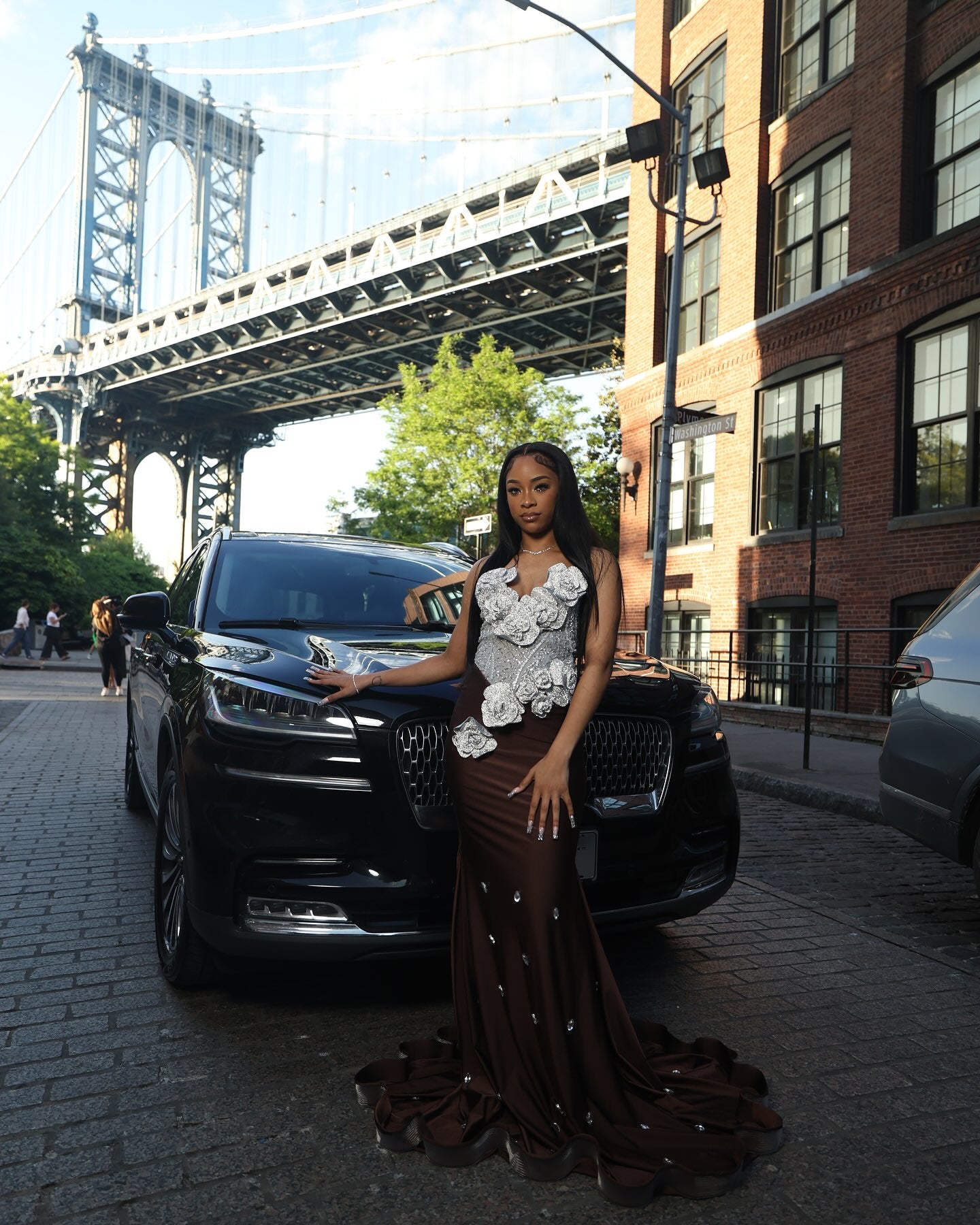 Chocolate Brown Mermaid Prom Dress Strapless Sweetheart Sheer Illusion Heavy Silver Crystal Rhinestone Beading Oversized 3D White Silver Satin Rose Bloom Bodice Scattered Rhinestone Ruffle Hem Sweep Train Gown