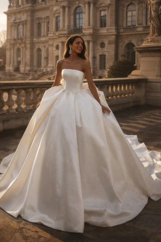 White Satin Ball Gown Wedding Dress Strapless Straight Neckline Oversized Bow Back Princess Bridal Gown with Cathedral Train