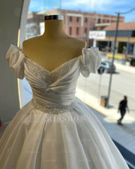 White off-the-shoulder beaded ball gown wedding dress
