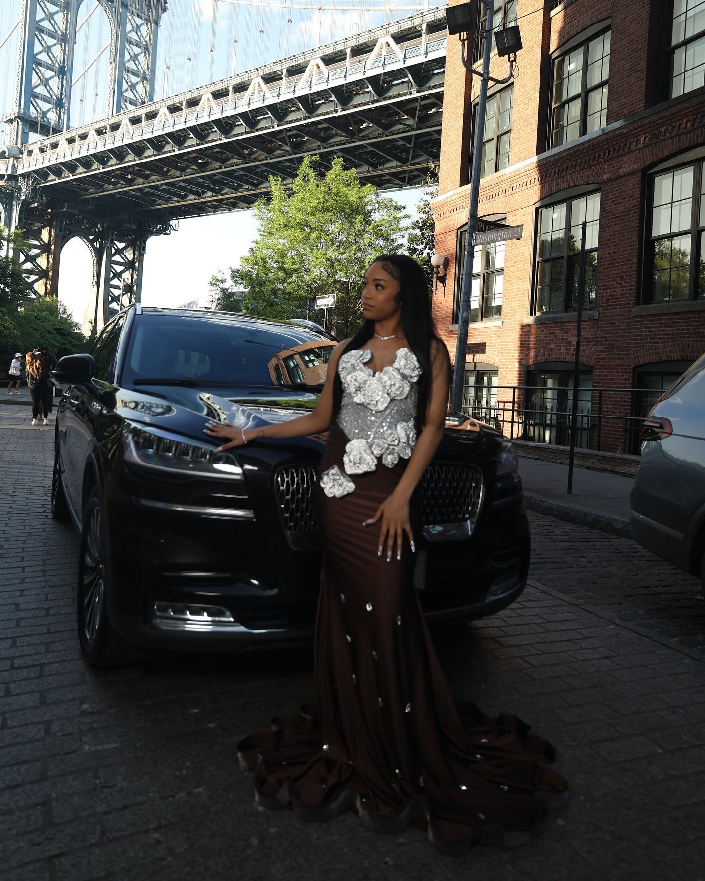 Chocolate Brown Mermaid Prom Dress Strapless Sweetheart Sheer Illusion Heavy Silver Crystal Rhinestone Beading Oversized 3D White Silver Satin Rose Bloom Bodice Scattered Rhinestone Ruffle Hem Sweep Train Gown