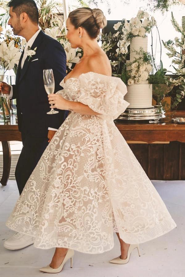 Ivory Tea Length Wedding Dress Strapless Sweetheart Sheer Illusion Boned Corset All-Over Ivory Gold Baroque Scroll Vine Lace Embroidery Thin White Satin Waist Sash Detachable Oversized Off Shoulder Tulle Puff Sleeve Multi-Tier Ruffle A-Line Bridal Gown