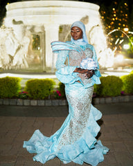 Light Blue Modest Muslim Mermaid Prom Dress High Neck Long Bell Sleeve Structured Cape Gold Crystal Fringe Tassel Gold Baroque Scroll Lace Rhinestone Embroidered Bodice Skirt Tiered Ruffle Hem Sweep Train Gown