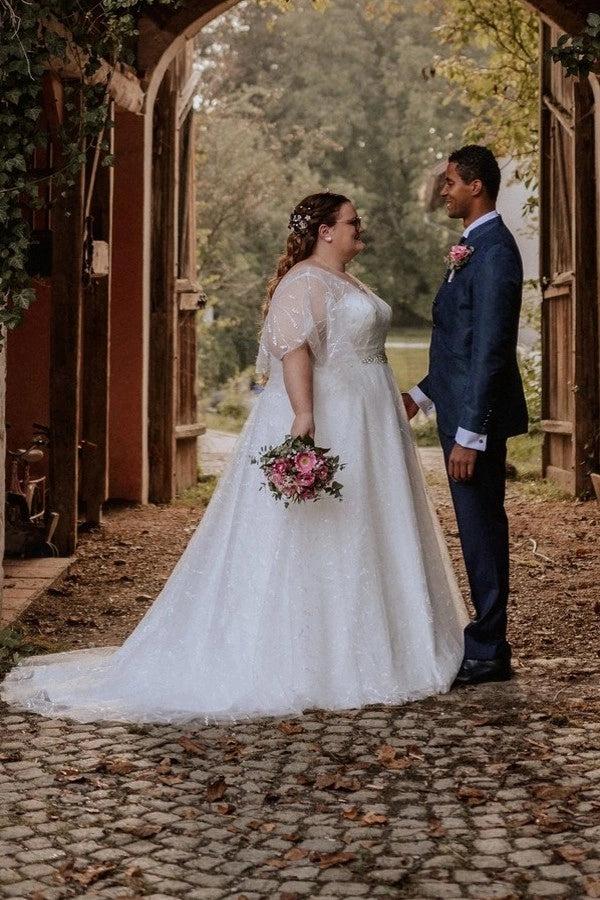 Plus Size White A-Line Wedding Dress V Neck Flutter Cape Sleeves Floral Embroidery Crystal Belt Glitter Tulle Bridal Gown with Sweep Train