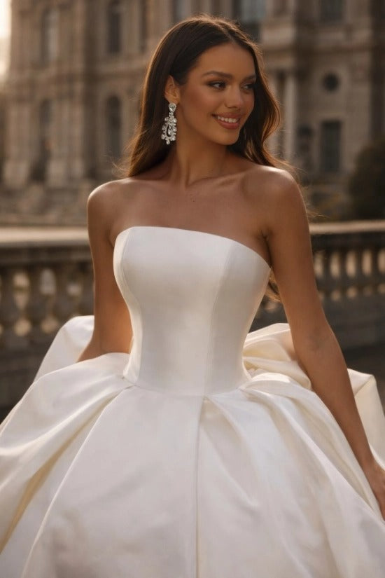 White Satin Ball Gown Wedding Dress Strapless Straight Neckline Oversized Bow Back Princess Bridal Gown with Cathedral Train