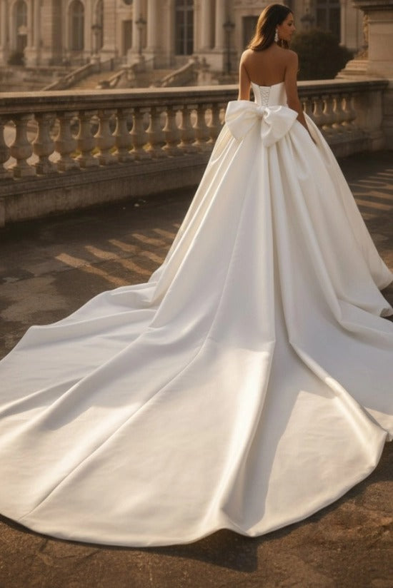 White Satin Ball Gown Wedding Dress Strapless Straight Neckline Oversized Bow Back Princess Bridal Gown with Cathedral Train